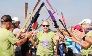 Woman running through tunnel of oars