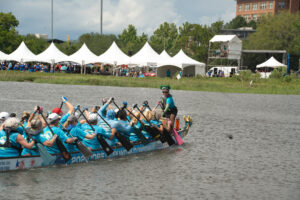 Dragon boat team paddling in the water