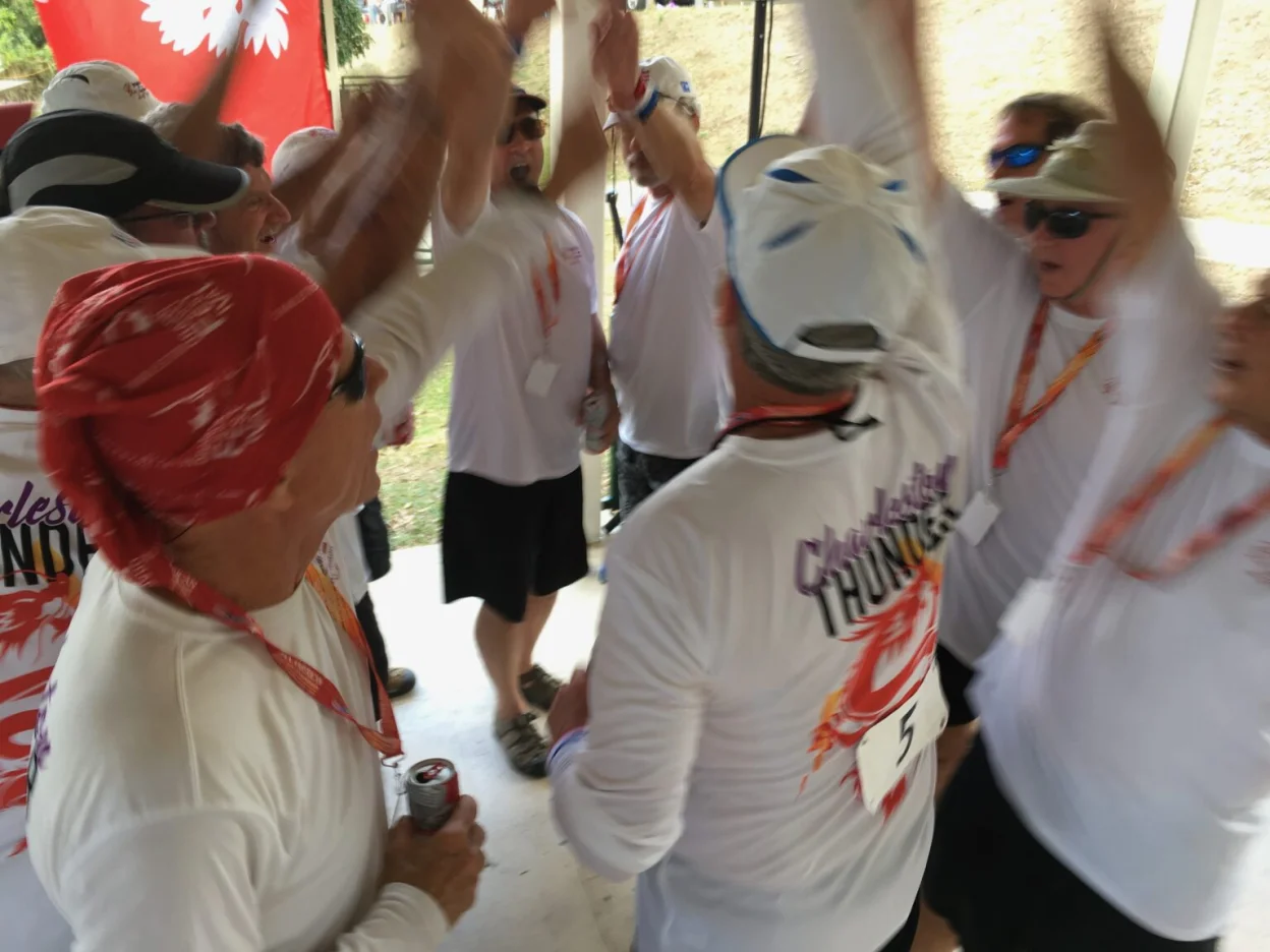 Group in matching white shirts doing a cheer